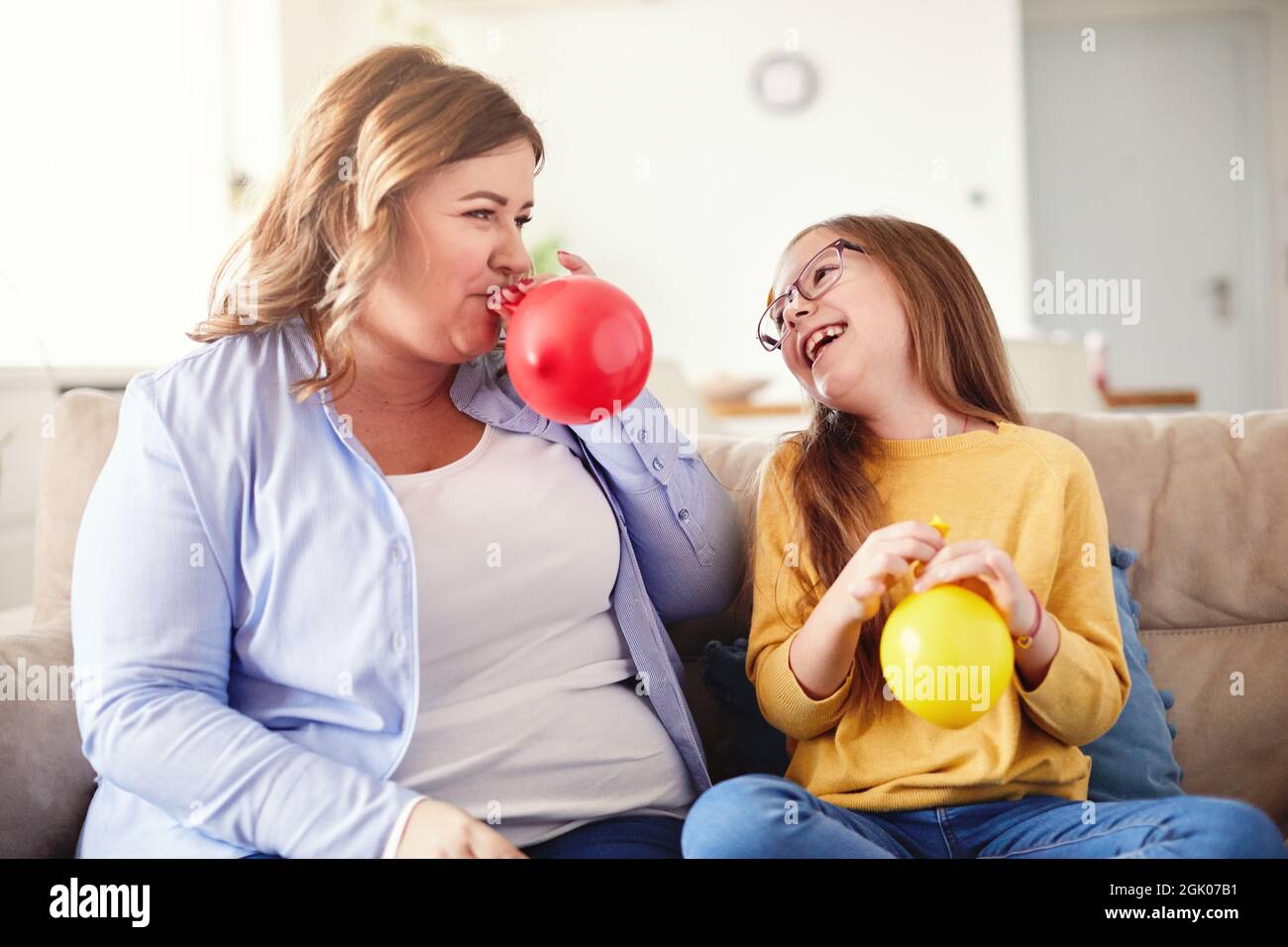 child daughter motherballoon blowing family happy playing kid childhood  Stock Photo - Alamy