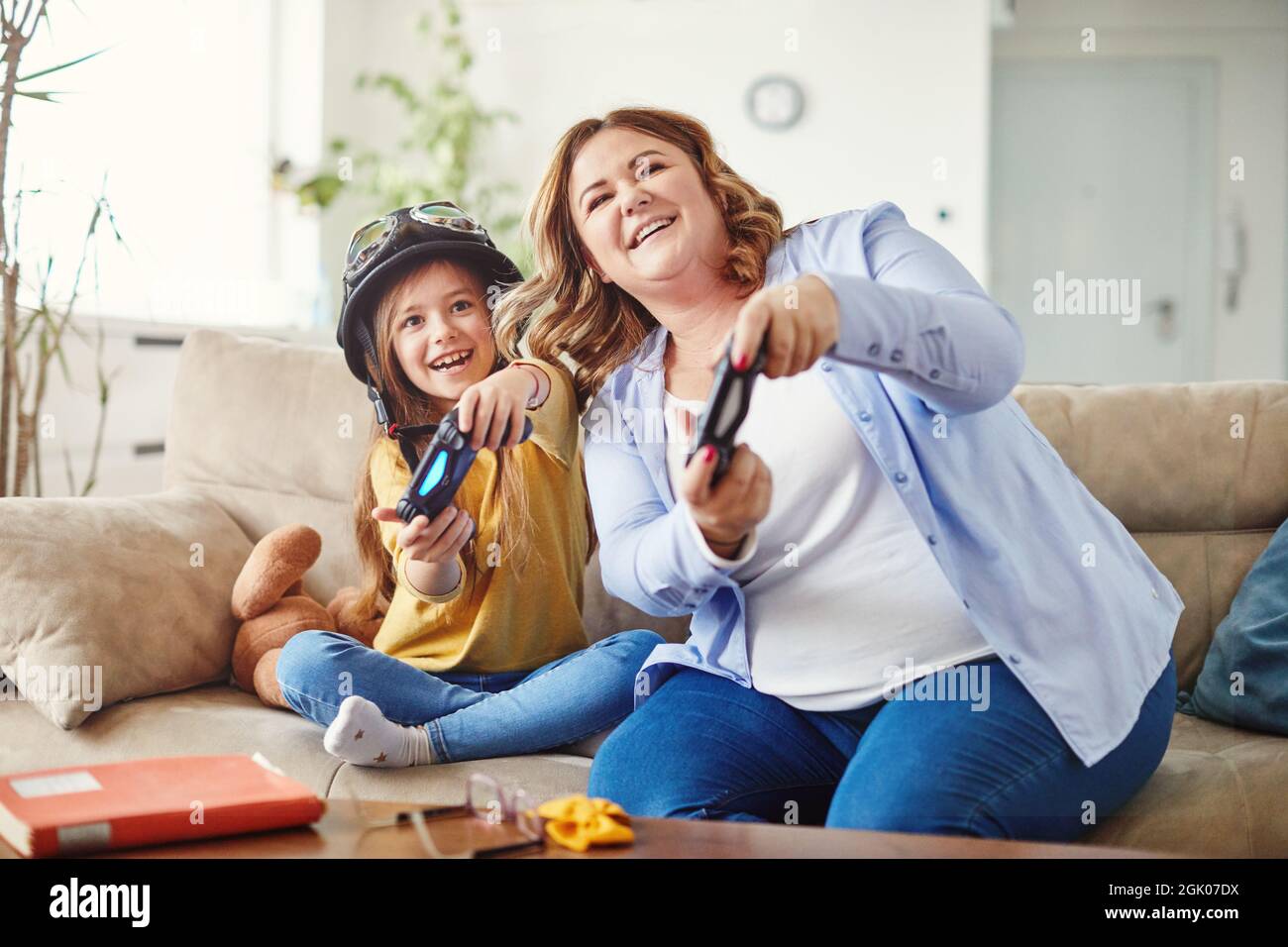 child daughter mother family happy playing console kid childhood Stock Photo