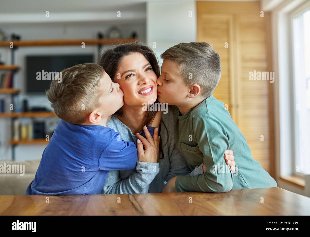 child boy son mother kiss kissing love happy family care Stock Photo