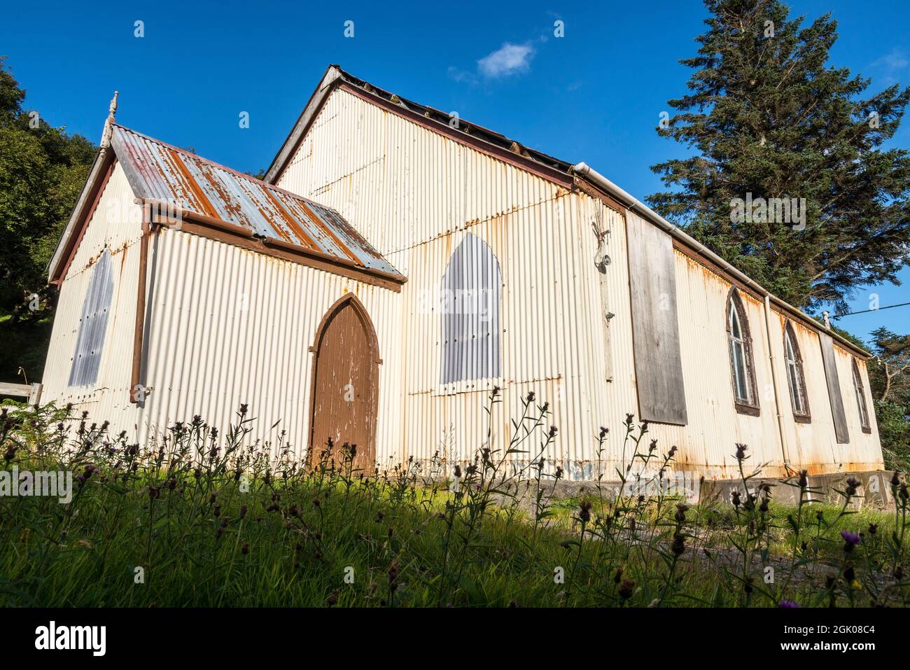 Prefabricated corrugated iron, or tin, church lit by bright evening sunlight at Torrisdale in an area generally referred to as Skerray near the NC500. Stock Photo