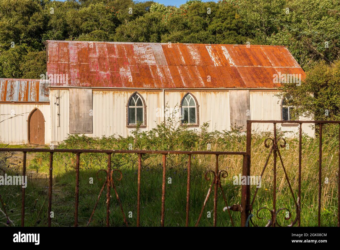 Prefabricated corrugated iron, or tin, church lit by bright evening sunlight at Torrisdale in an area generally referred to as Skerray near the NC500. Stock Photo