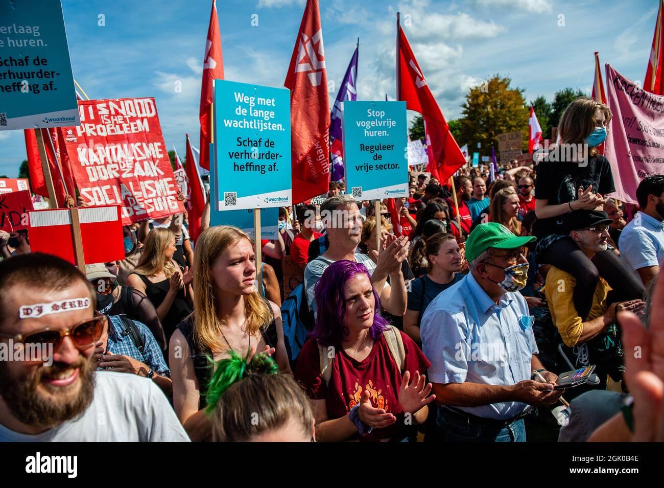 Thousands of protesters hold placards with messages against the ...