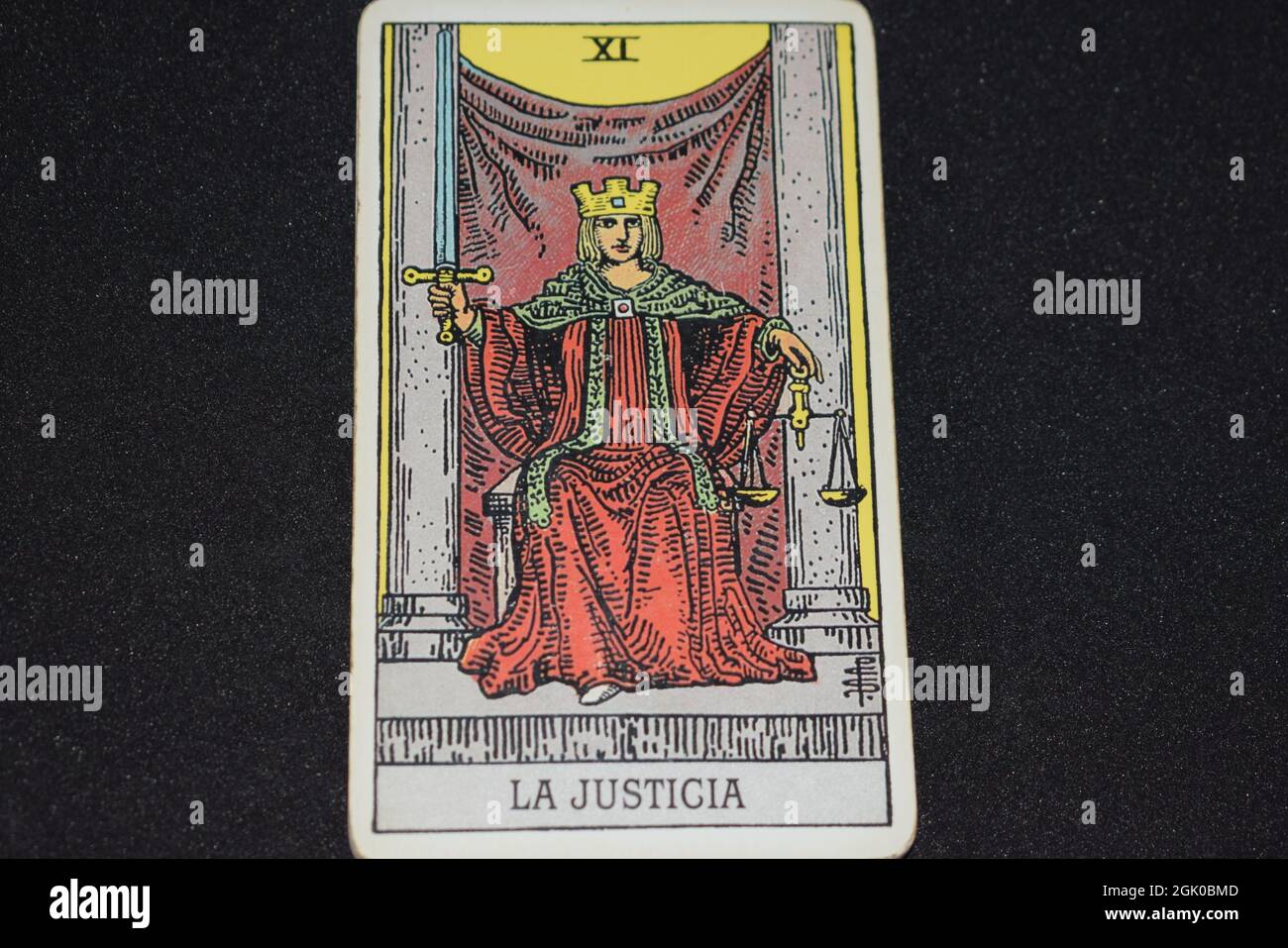The tarot card number 11 represents JUSTICE in the tarot cards of the major arcana on a black background. Stock Photo