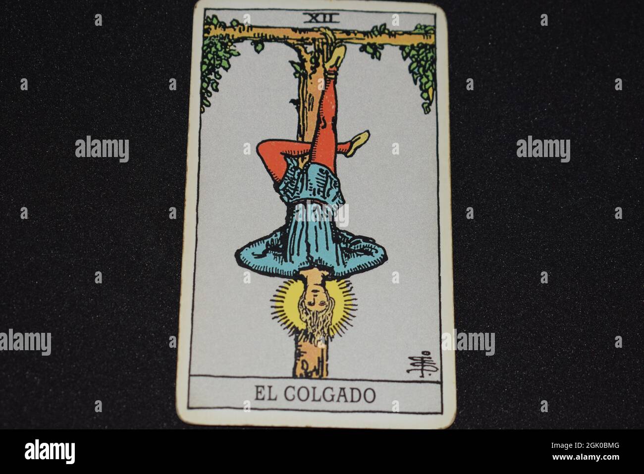 The tarot card number 12 represents the one hanging on the tarot cards of  the major arcana on a black background Stock Photo - Alamy
