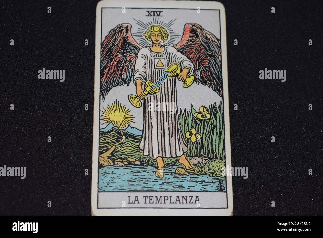 The tarot card number 14 represents THE TEMPERANCE in the tarot cards of the major arcana on a black background. Stock Photo
