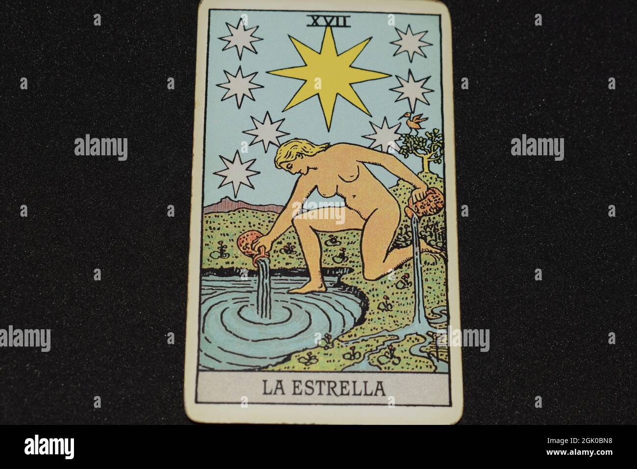 Tarot card number 17 represents THE STAR in the tarot cards of the major  arcana on a black background Stock Photo - Alamy