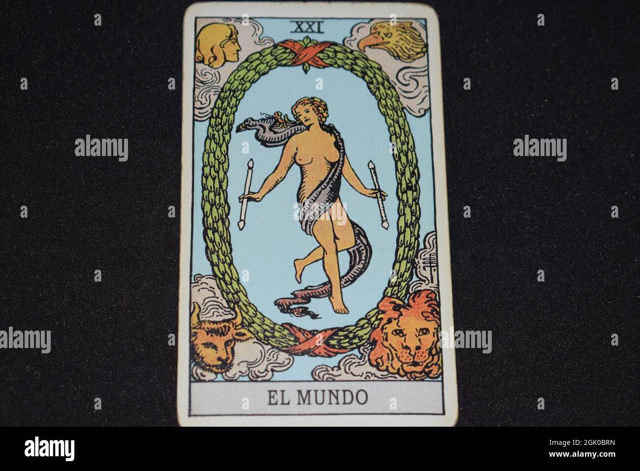 The tarot card number 21 represents THE WORLD in the tarot cards of the major arcana on a black background. Stock Photo