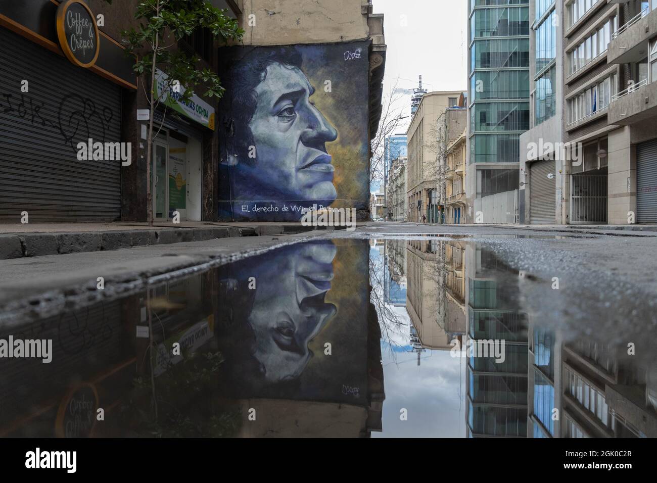 Santiago, Metropolitana, Chile. 12th Sep, 2021. A mural with the face of Victor Jara is reflected in a pool of water, after a rain at night in Santiago, Chile. (Credit Image: © Matias Basualdo/ZUMA Press Wire) Credit: ZUMA Press, Inc./Alamy Live News Stock Photo