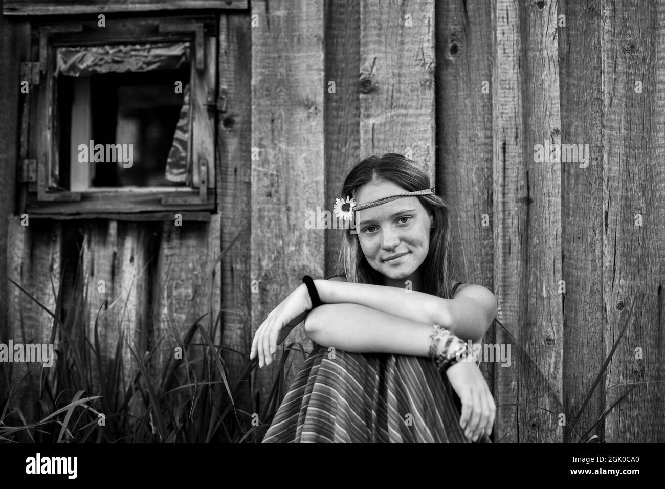 An girl with hippie jewelry in rural surroundings. Black and white photo. Stock Photo
