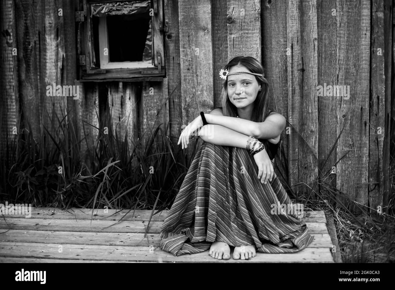 A girl with hippie jewelry outdoors in rural surroundings. Black and white photo. Stock Photo