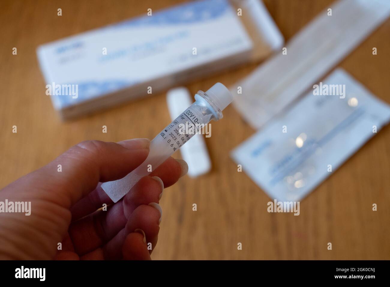 COVID-19 Ag Test kit for self-testing. Corona virus diagnosis. Open package on wooden home table. Stock Photo