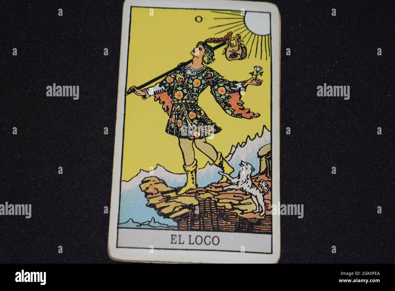 Tarot card number 0 represents THE FOOL in the tarot cards of the major arcana on a black background. Stock Photo