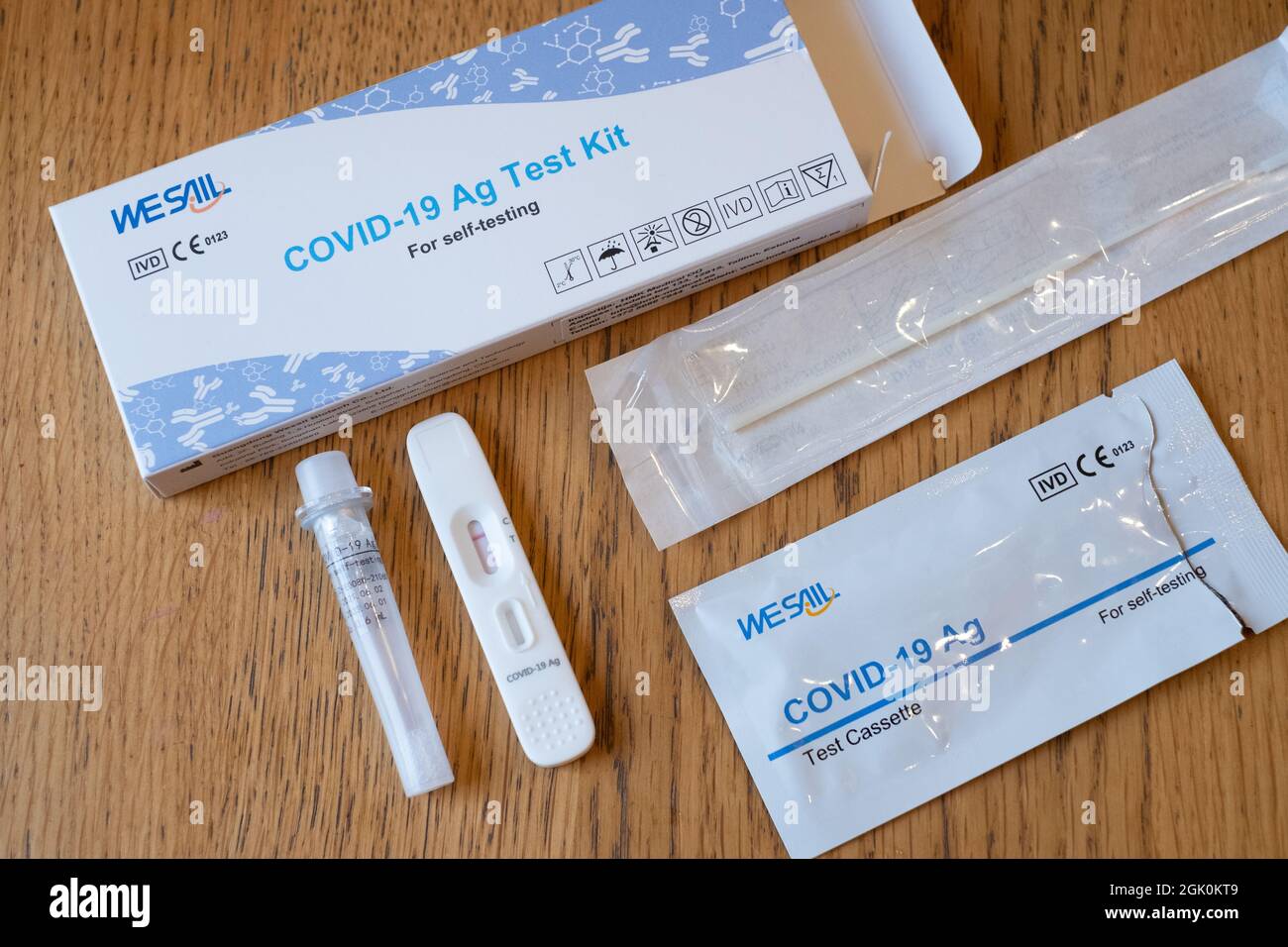 Tallinn, Estonia - September 12, 2021: COVID-19 Ag Test kit for self-testing. Corona virus diagnosis. Open package on wooden home table. Stock Photo