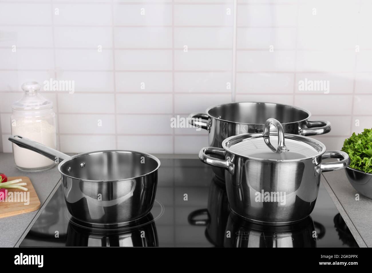 Utensils for cooking classes on electric stove in kitchen Stock Photo -  Alamy