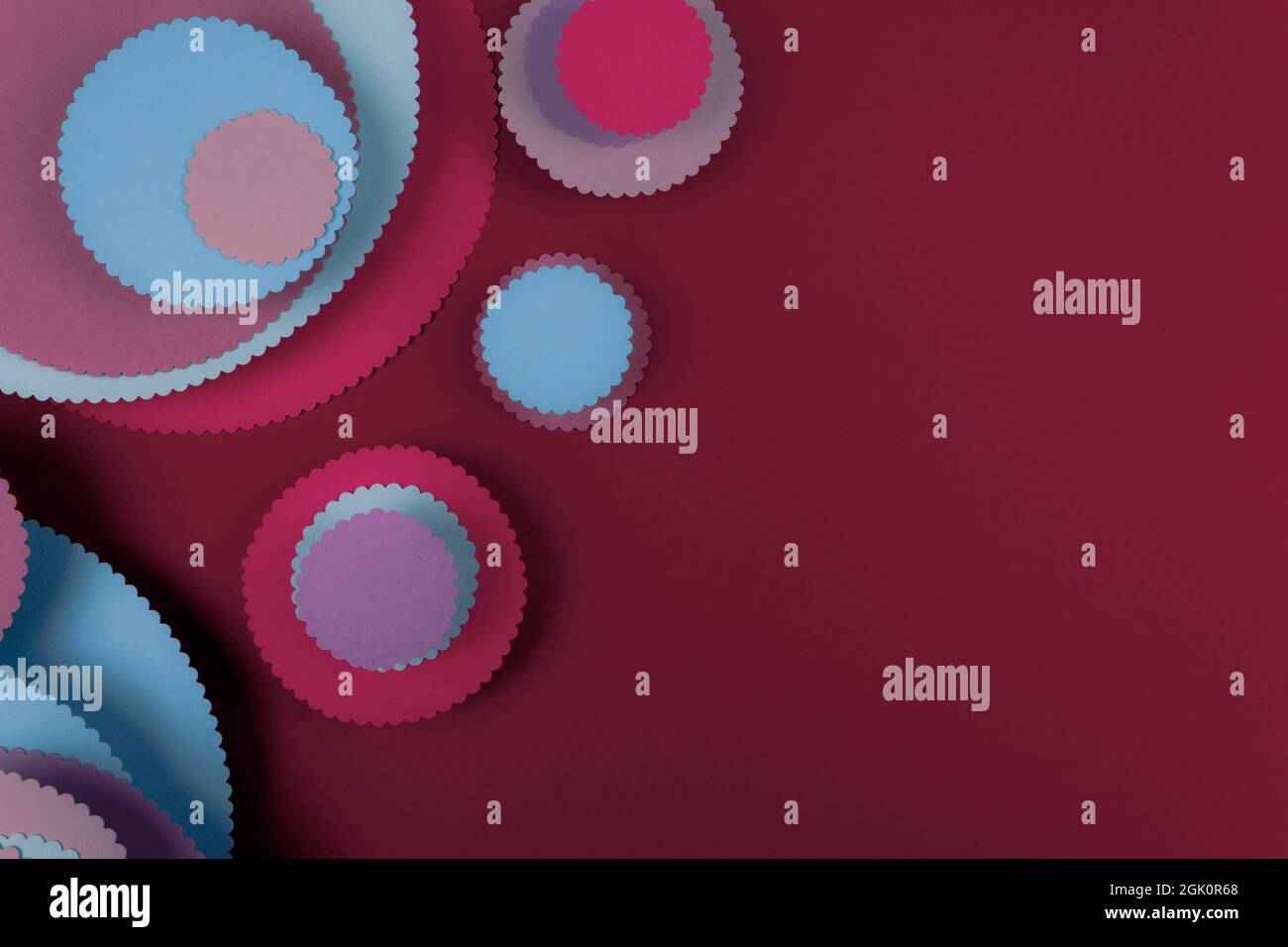 Abstract colored paper circles shapes in red background. Minimalist