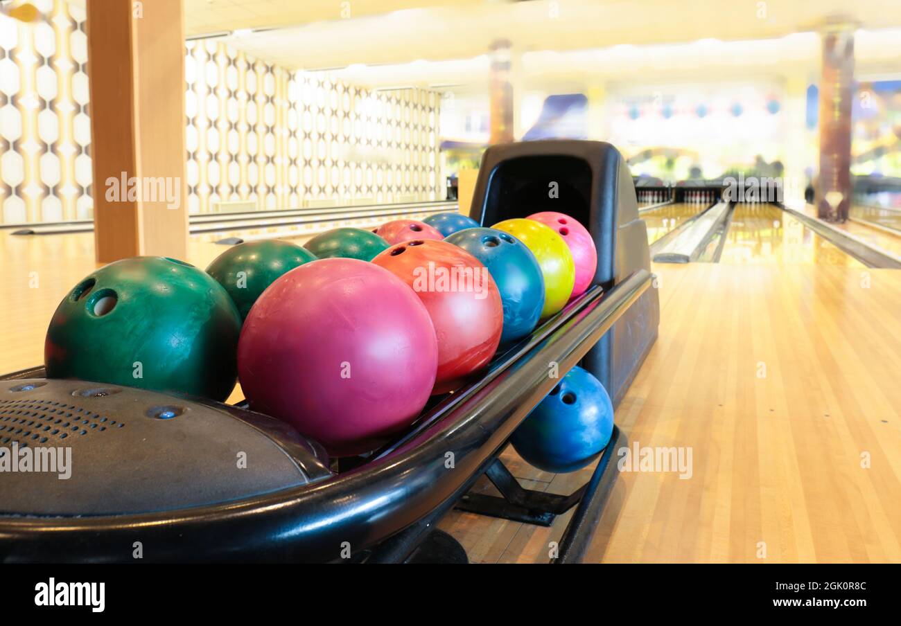 Colorful bowling balls in return machine Stock Photo Alamy