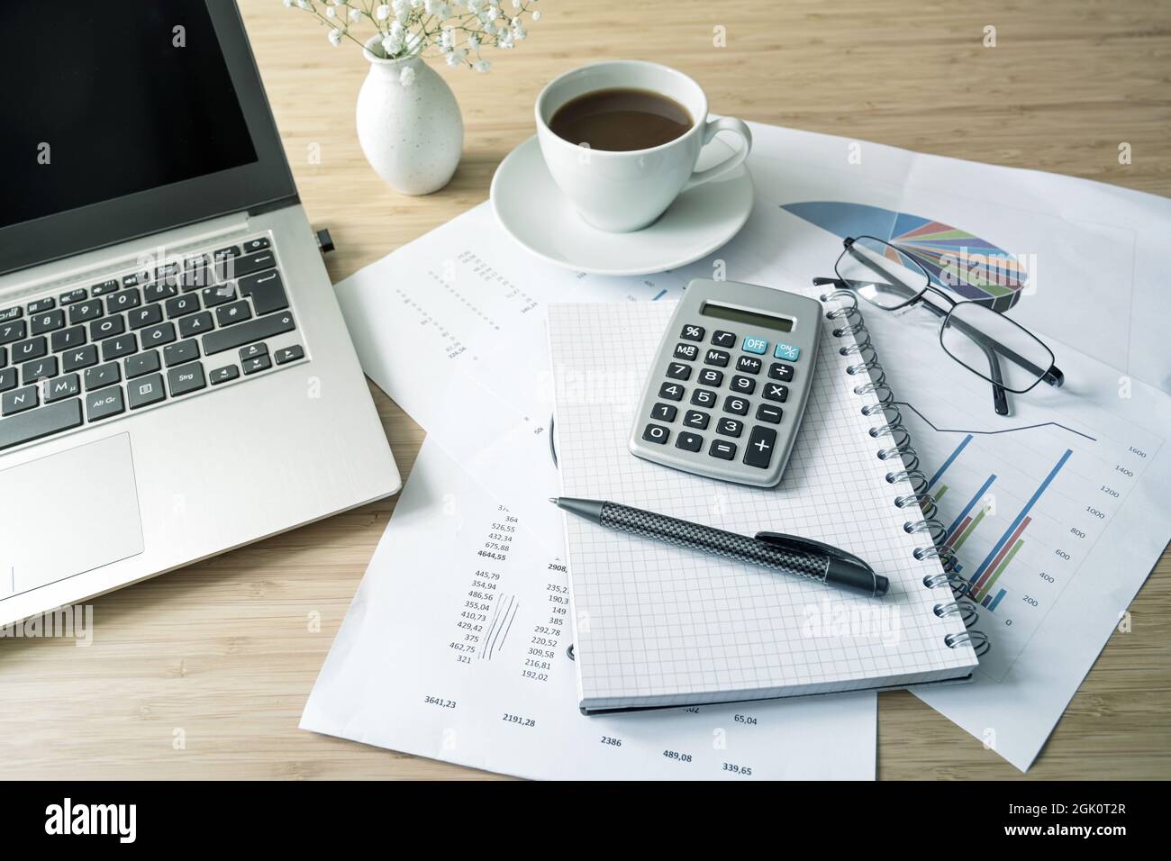 Finance accounting on an office desk with papers, laptop computer ...