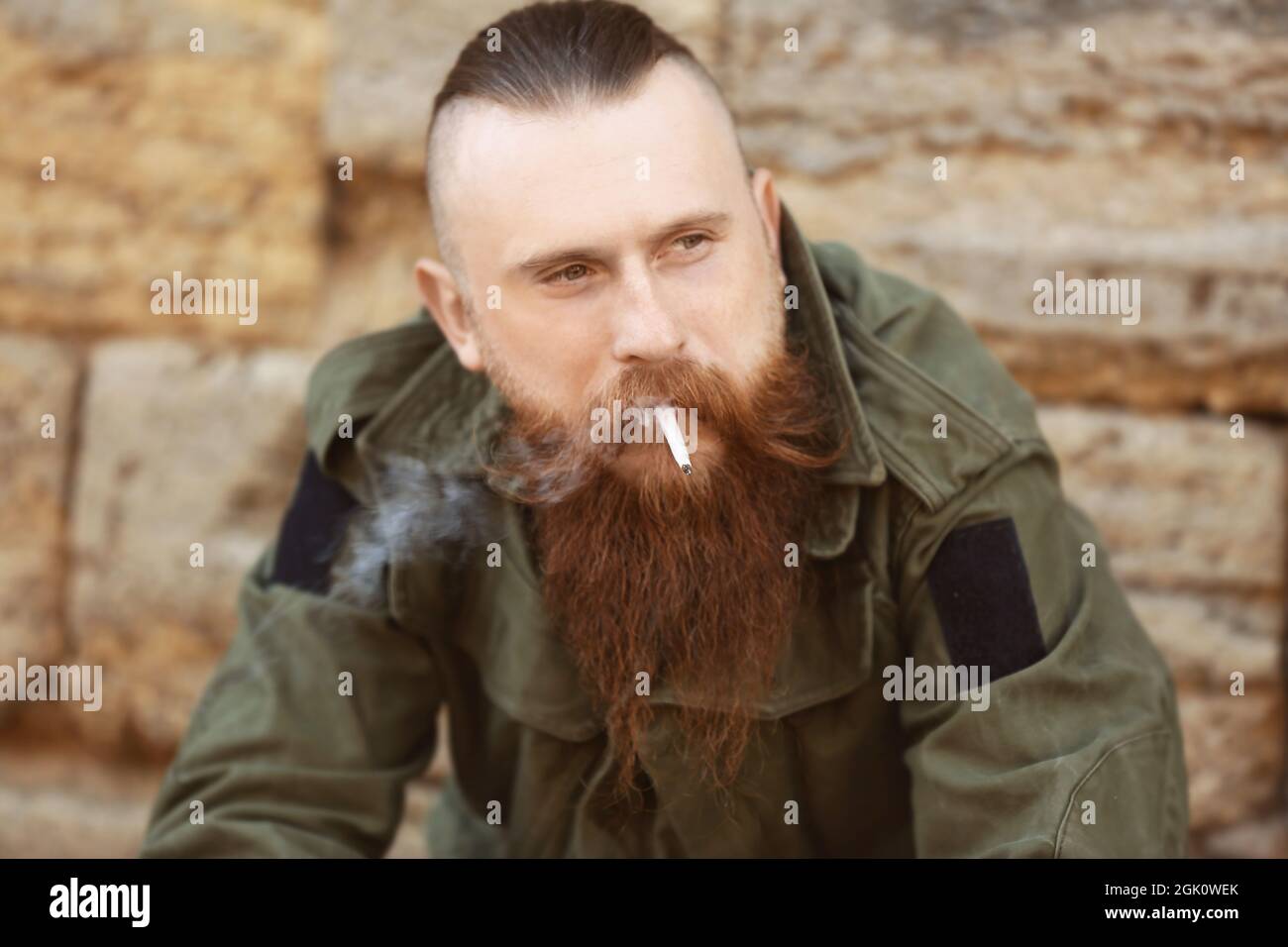 Bearded man smoking weed outdoors Stock Photo