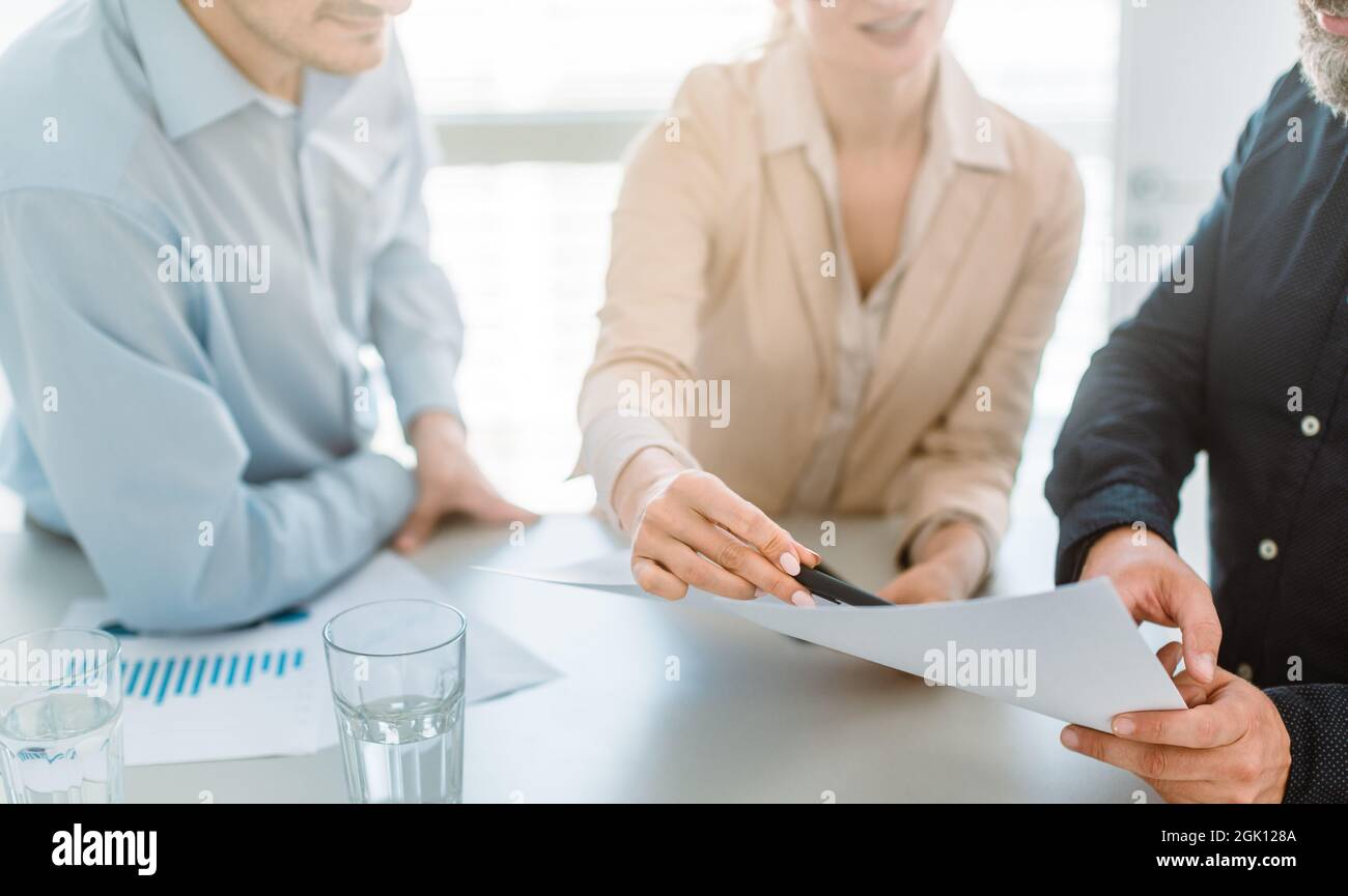 Business people discussing figures in a meeting Stock Photo