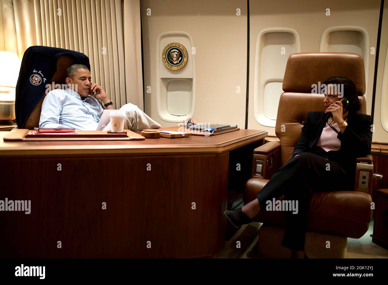 President Barack Obama, aboard Air Force One, talks on the phone with President Hamid Karzai of Afghanistan, who was unable to travel from Kabul to meet with President Obama at Bagram Airfield, Afghanistan, Sunday, May 25, 2014. National Security Advisor Susan E. Rice sits at right. (Official White House Photo by Pete Souza) Stock Photo