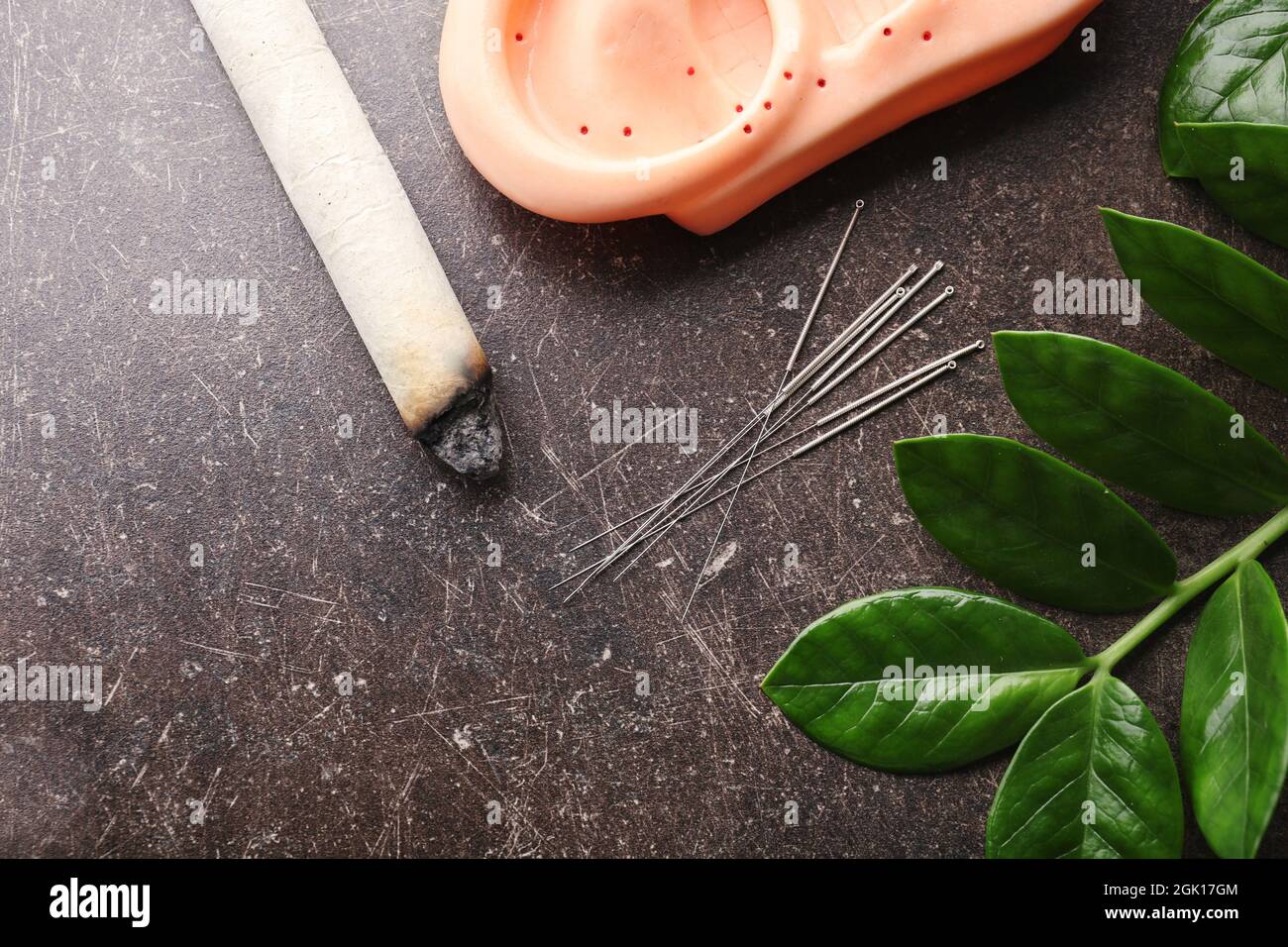 Composition with acupuncture supplies on dark textured background Stock