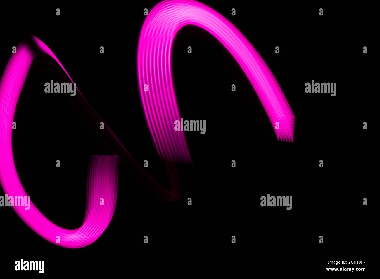 Nice pink lines on a black background with space for text. Stock Photo