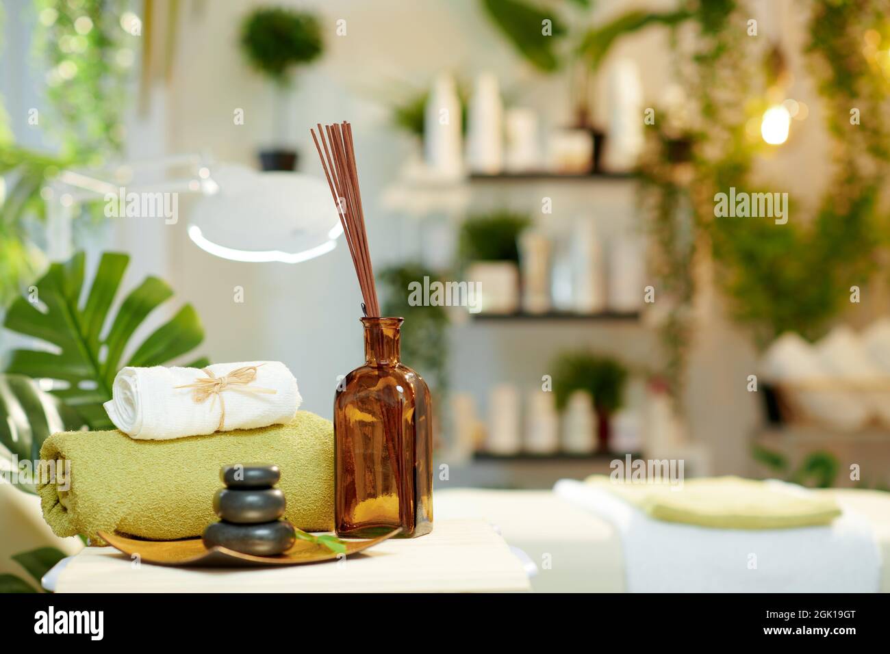 towels, hot stone massage, essential oils and massage table in modern