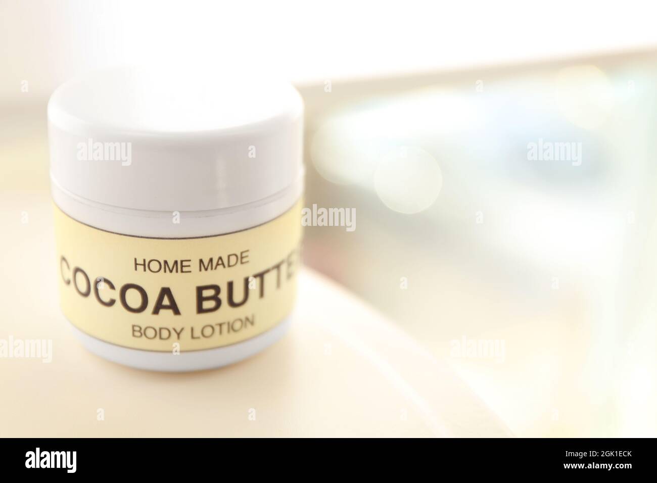 Jar of cocoa butter lotion on table Stock Photo Alamy