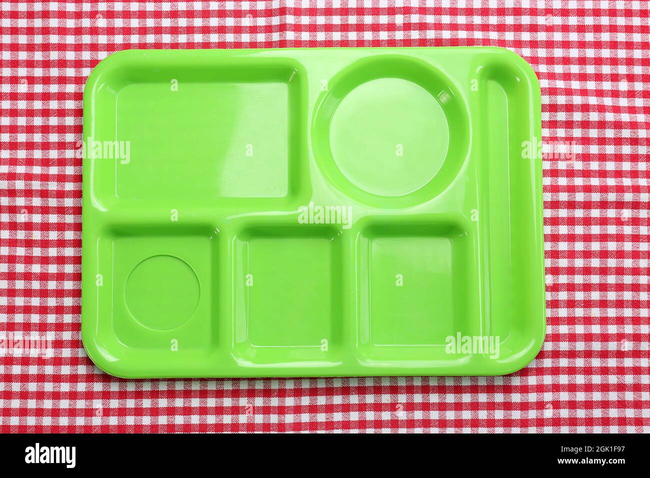 Empty serving tray for food on tablecloth. Concept of school lunch