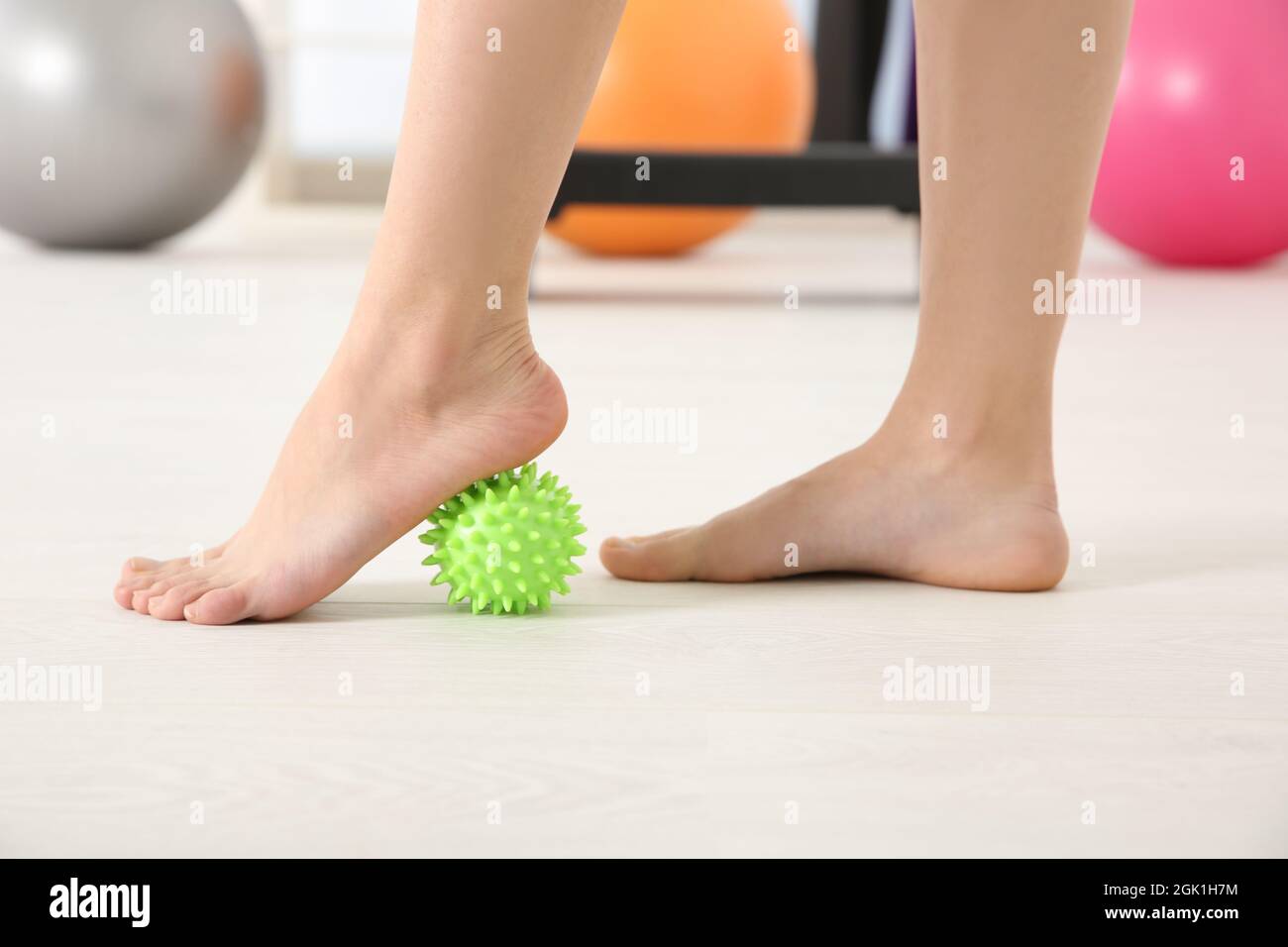 Feet of woman doing exercises with stress ball in clinic Stock Photo
