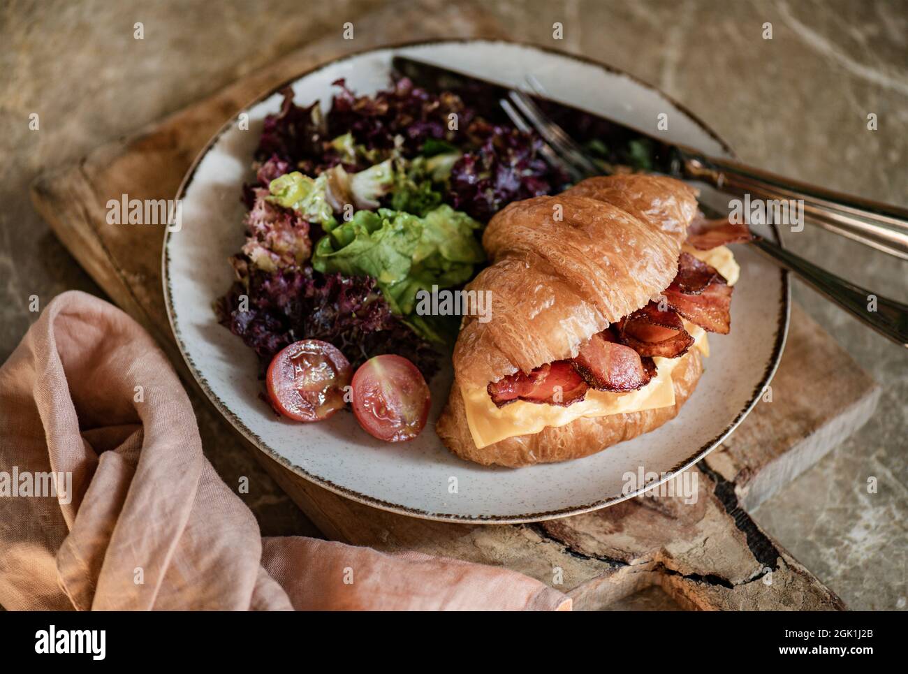 Bacon and cheddar cheese stuffed French croissant, horizontal composition Stock Photo