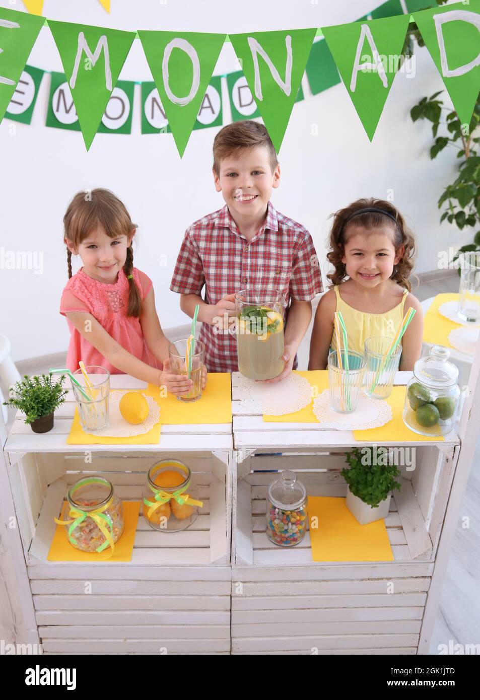Cute little kids selling lemonade at counter Stock Photo Alamy
