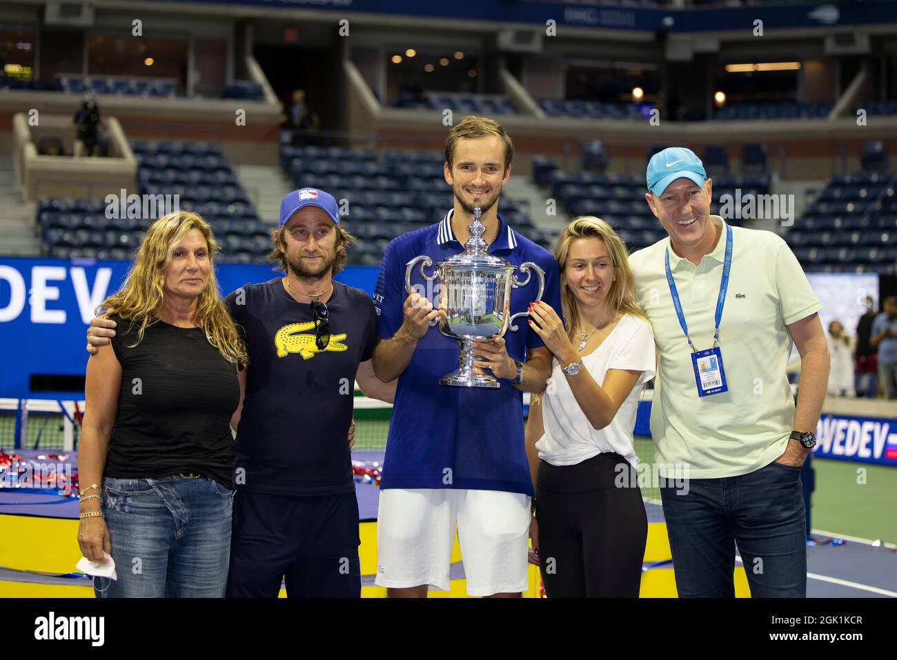New York, USA, 12 September, 2021 Daniil Medvedev (RUS) poses with the  trophy, his wife and his support staff after winning the men's final  against Novak Djokovic (SRB) on day 14 at