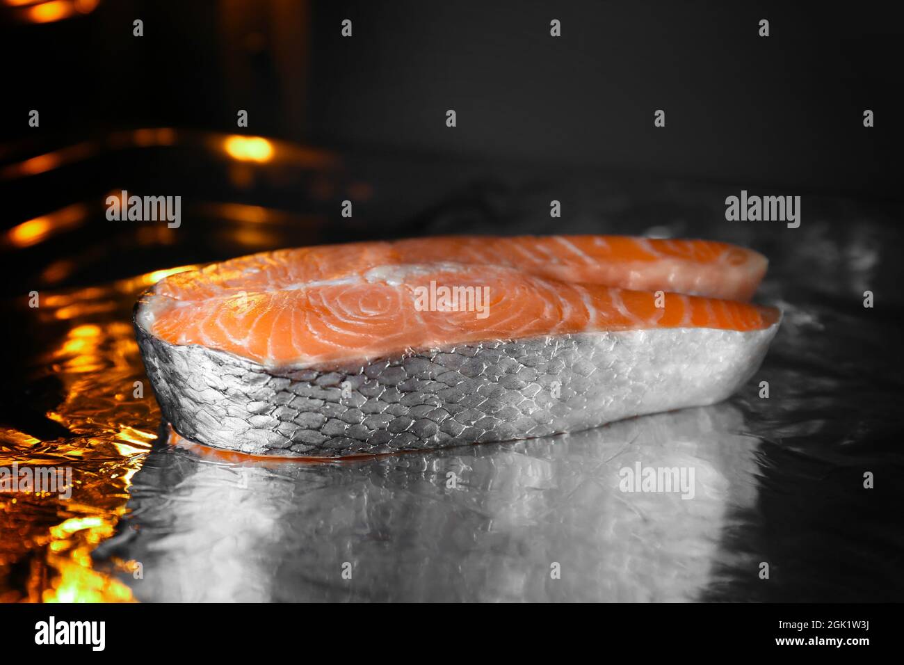 Baking sheet with foil and piece of salmon in oven Stock Photo - Alamy