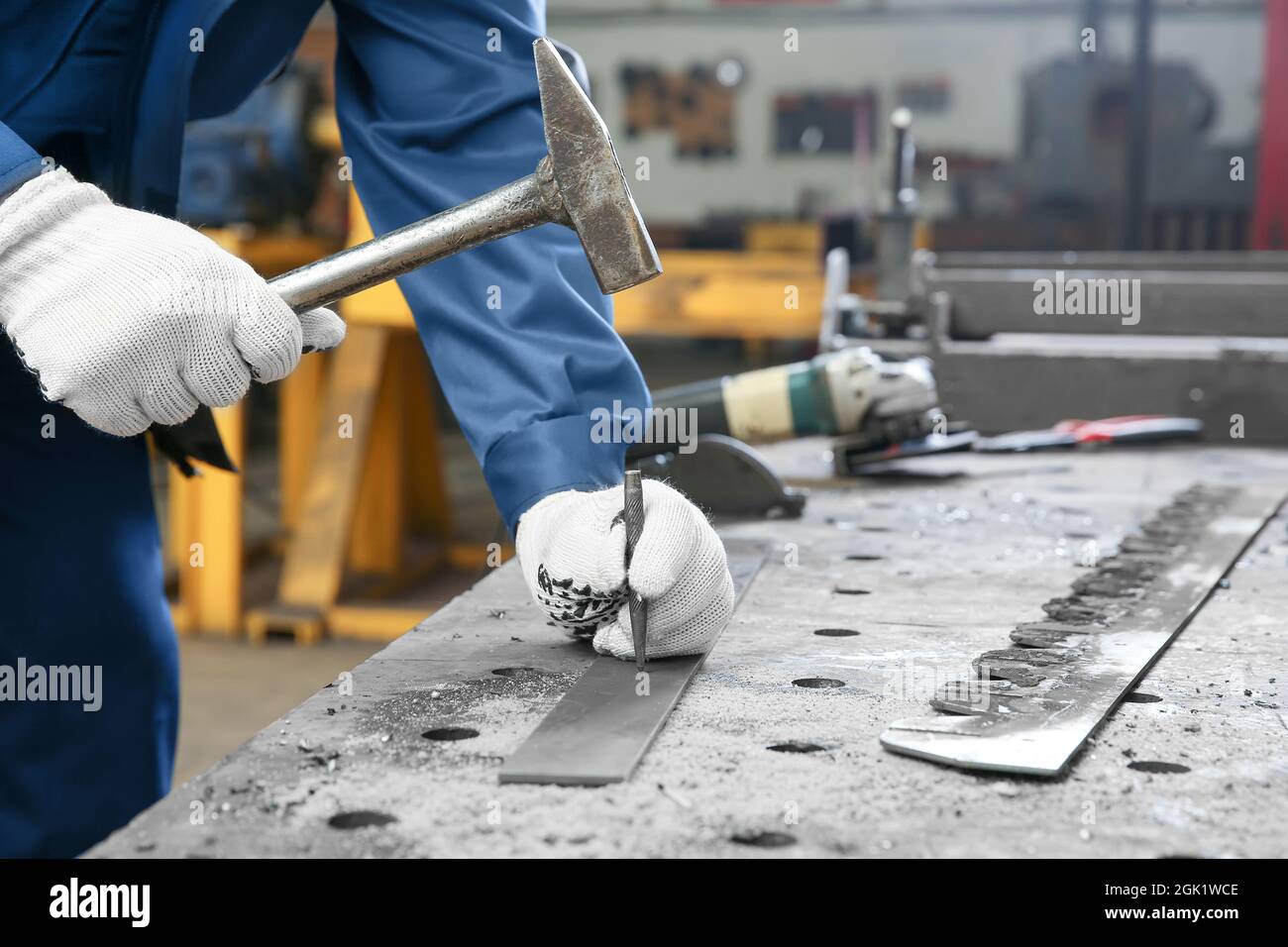 Man using hammer for metalworking in shop Stock Photo Alamy