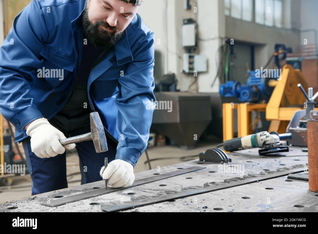 Man using hammer for metalworking in shop Stock Photo Alamy
