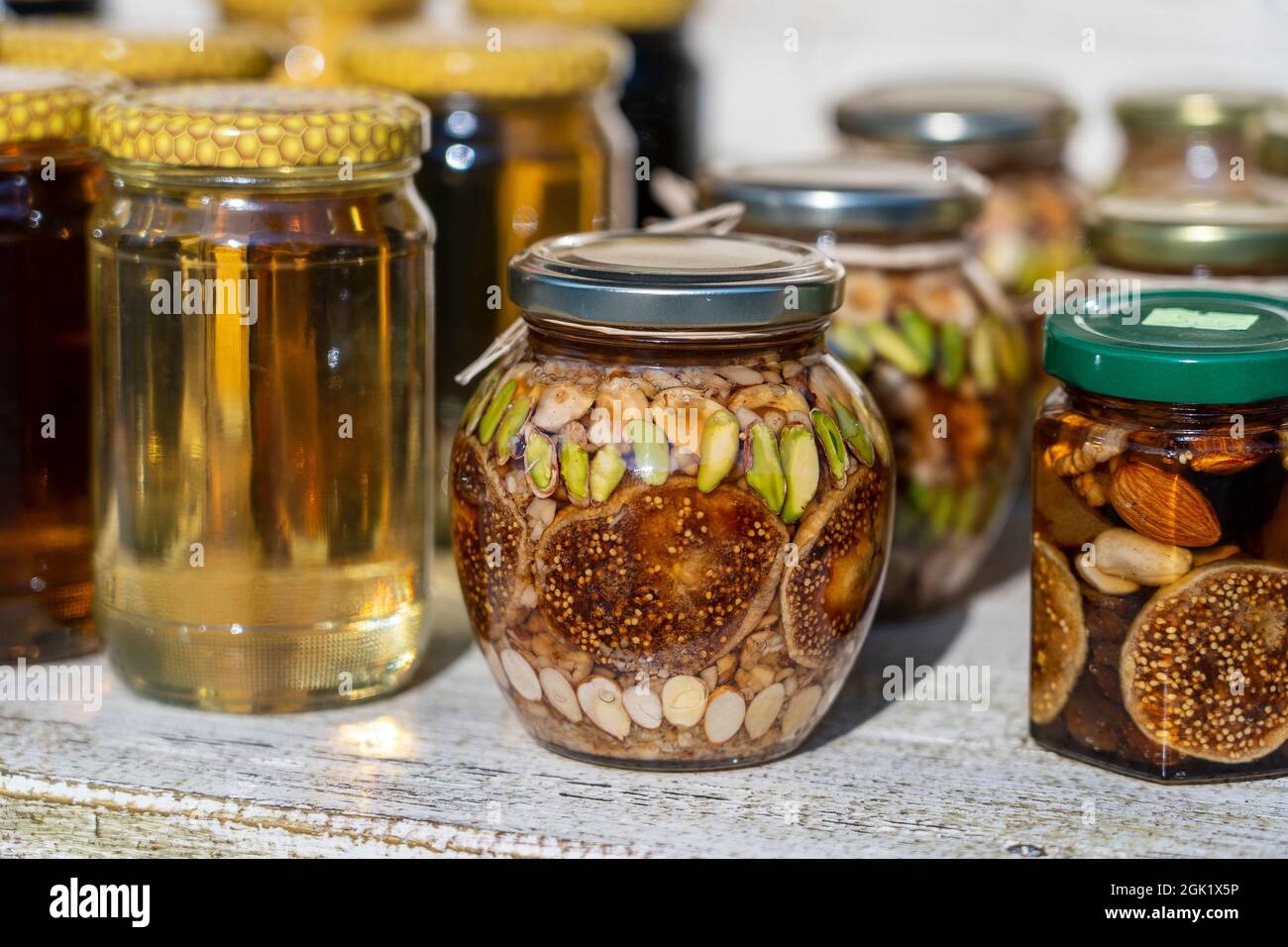 Honey in a glass jar with nuts and fruits for sell for tourist in  Montenegro food market, close up Stock Photo - Alamy