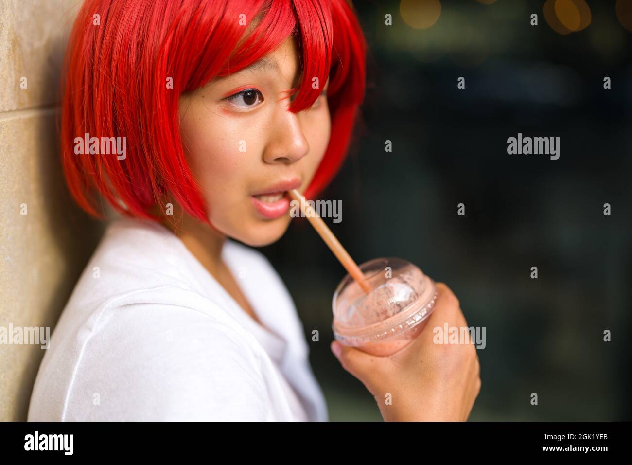 Closeup of Teenage Asian Cosplay Actress Drinking a Smoothie | Teenage Girl Drinking a Smoothie Stock Photo