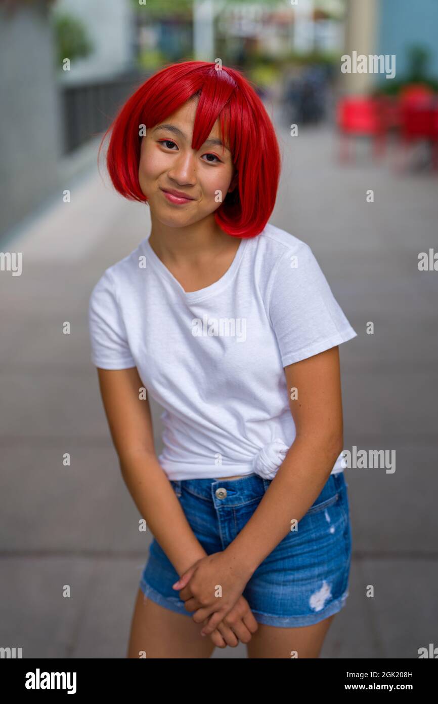 Red Blood Cell Cosplay Actress Standing on Sidewalk | Asian Cosplay Actress Stock Photo
