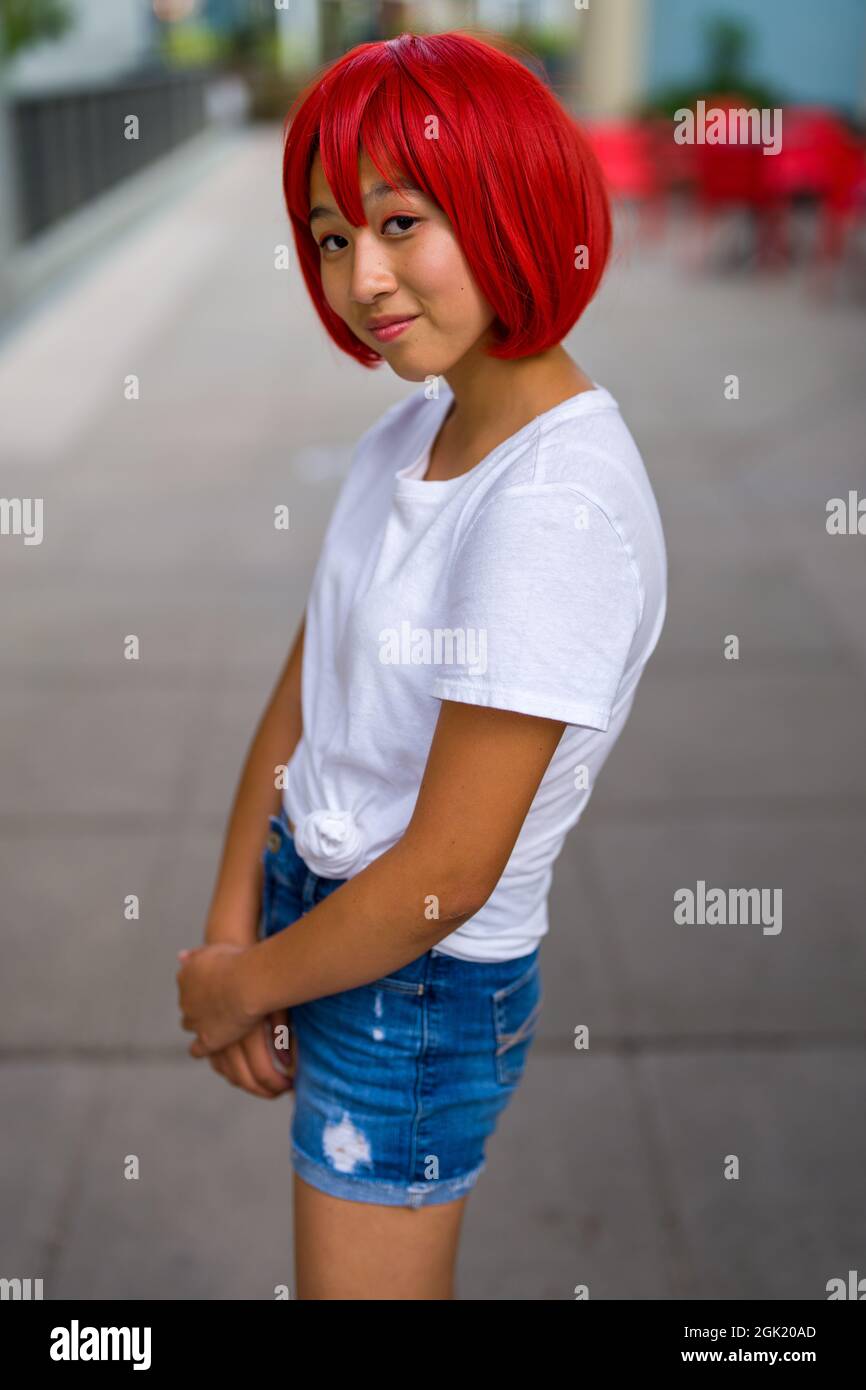 Red Blood Cell Cosplay Actress Standing on Sidewalk | Asian Cosplay Actress Stock Photo