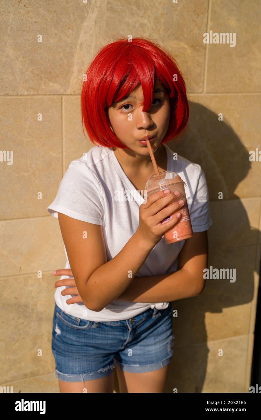 Cosplay Actress Red Blood Cell Drinking a Smoothie | Teenage Asian Girl Drinking a Smoothie Stock Photo