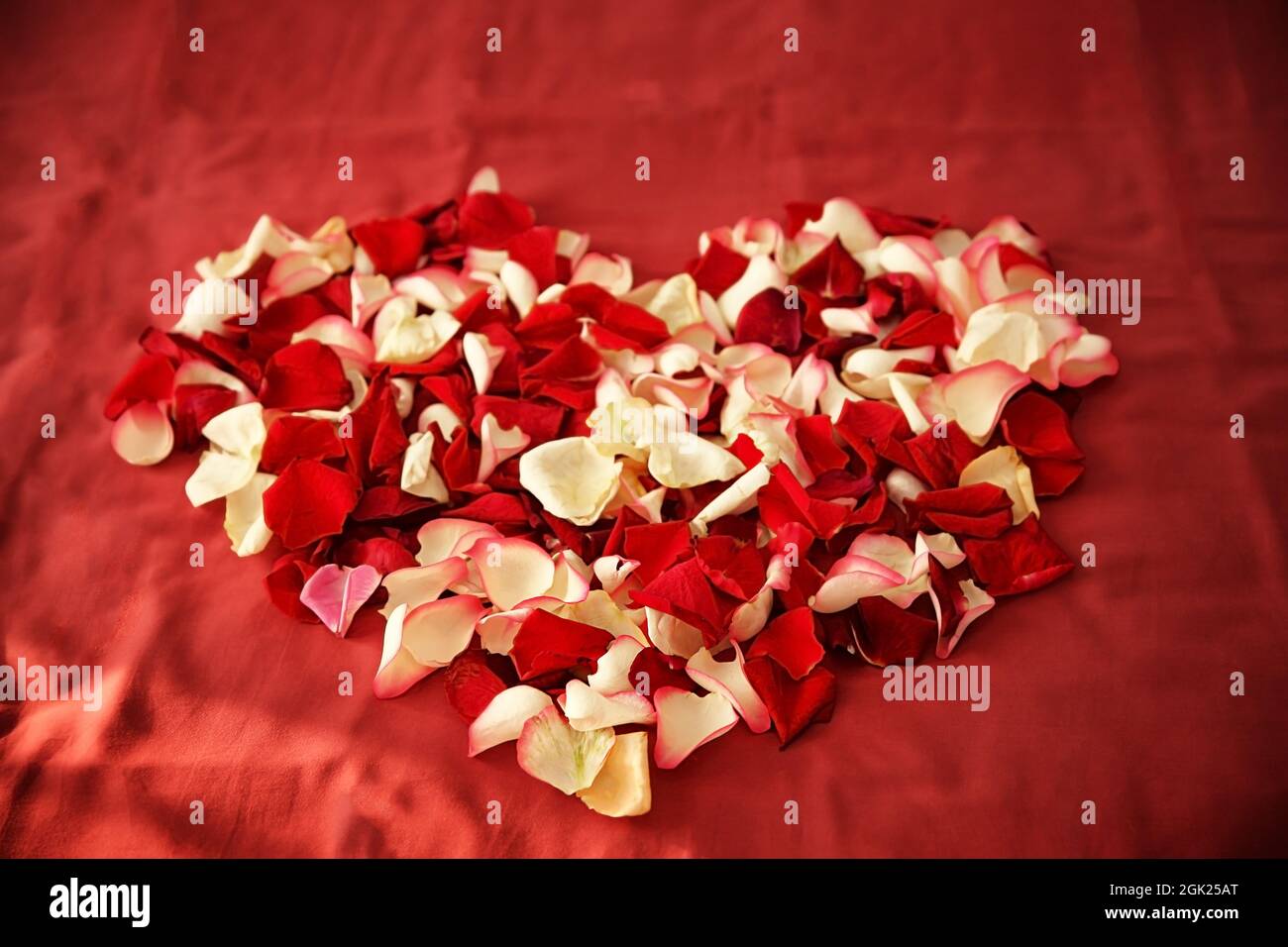 Heart made of rose petals on bed in hotel room Stock Photo Alamy