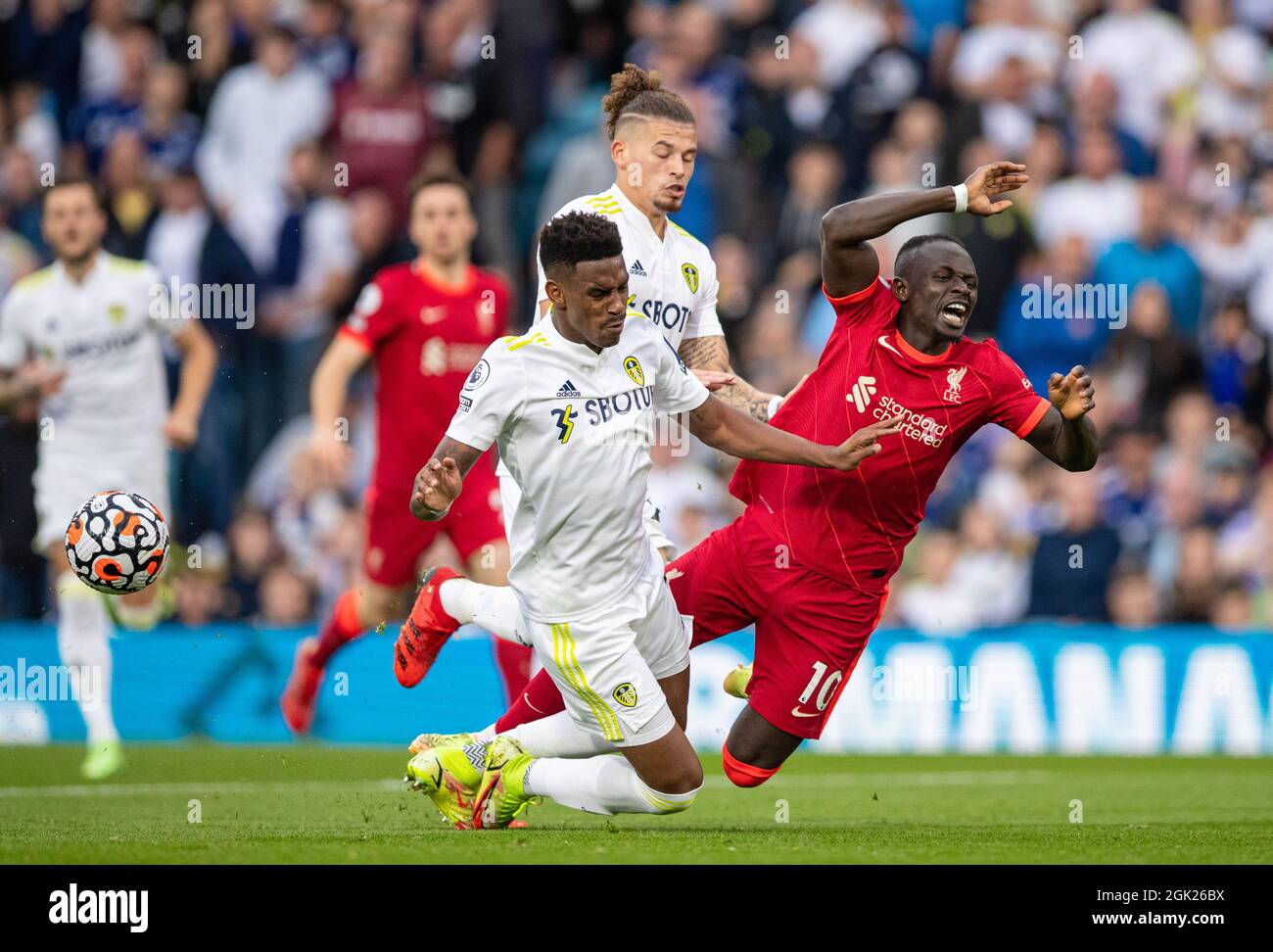 Leeds. 13th Sep, 2021. Liverpool's Sadio Mane (R) is brought down by Leeds United's Junior Firpo (L) during the Premier League football match between Leeds United and Liverpool in Leeds, Britain, on Sept. 12, 2021. Credit: Xinhua/Alamy Live News Stock Photo