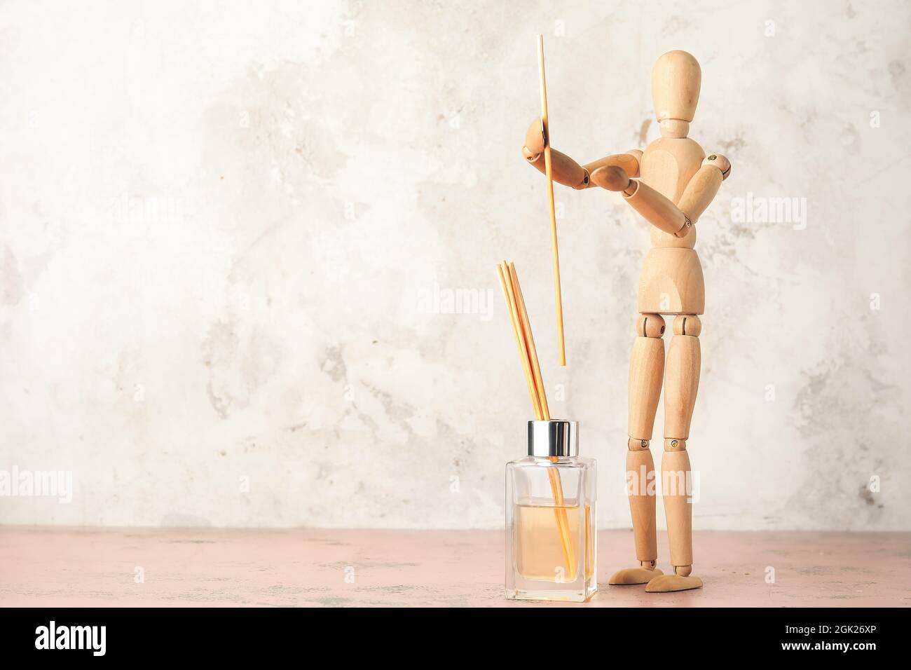 Wooden mannequin with aroma diffuser on light background Stock Photo