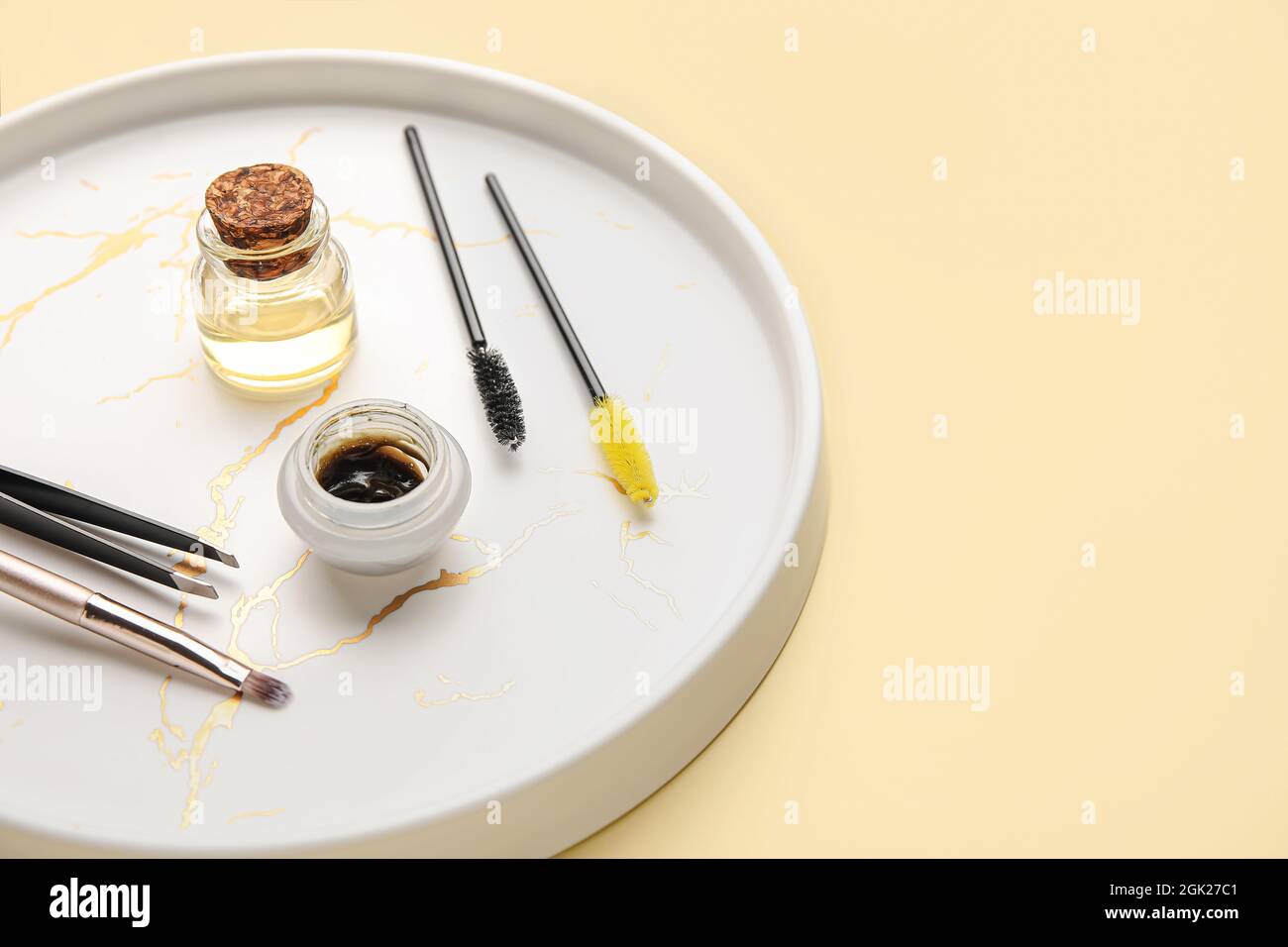 Tray with henna and tools for eyebrows correction on color background Stock Photo