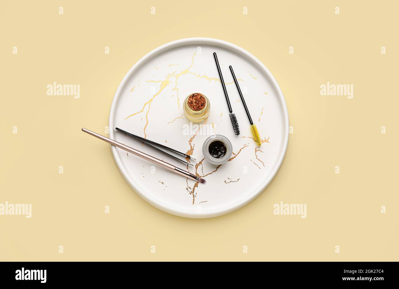 Tray with henna and tools for eyebrows correction on color background Stock Photo