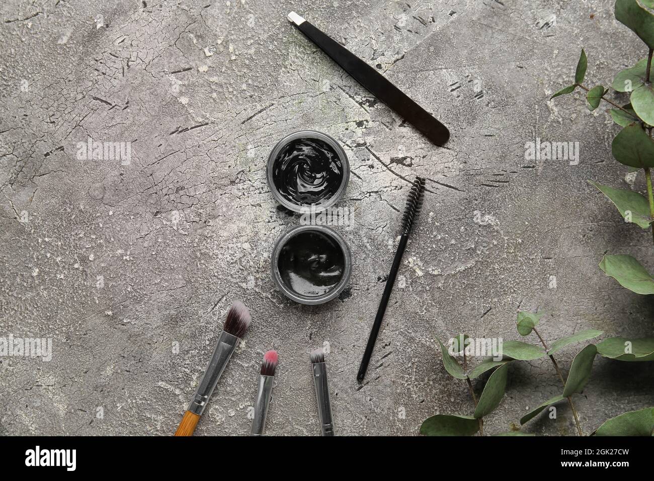 Henna and tools for eyebrows correction on grunge background Stock Photo