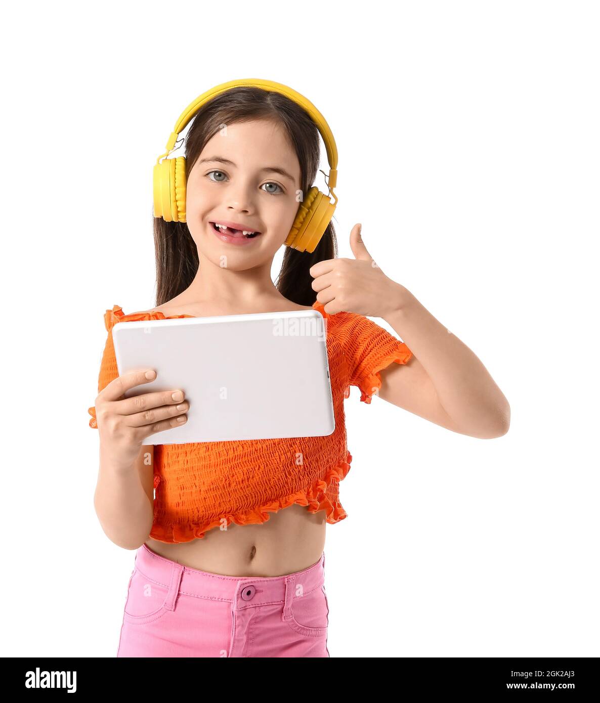 Little girl with headphones and tablet computer showing thumb-up on ...
