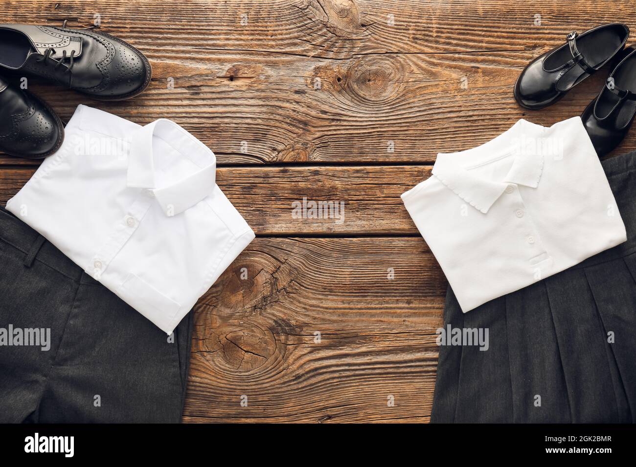 Stylish school uniforms and shoes on wooden background Stock Photo Alamy