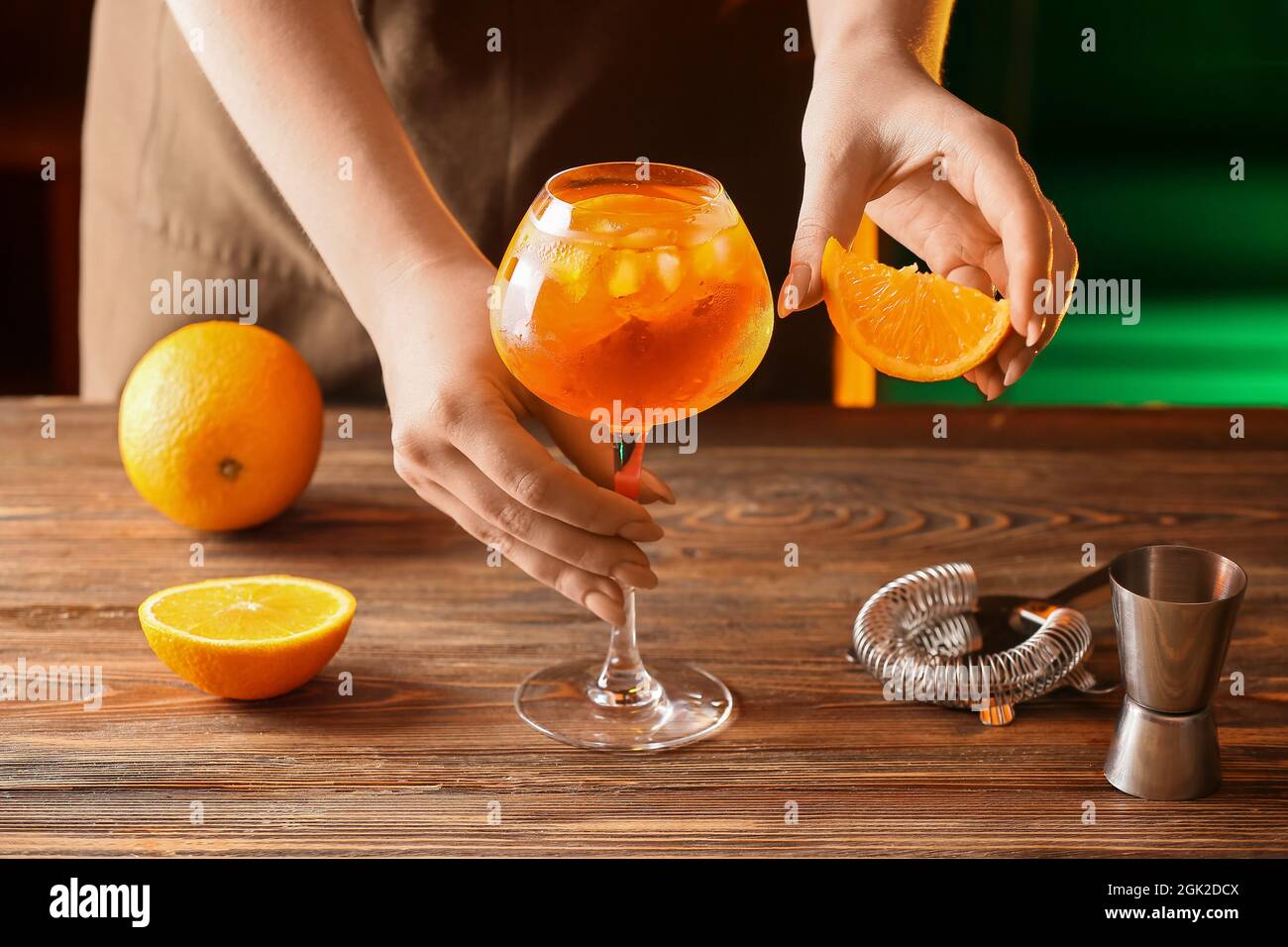 Woman preparing tasty aperol spritz cocktail at table Stock Photo
